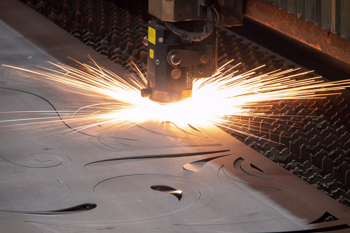 Precision metal laser cutting operation at MMCTORK manufacturing facility producing components for seed processing machinery and industrial equipment